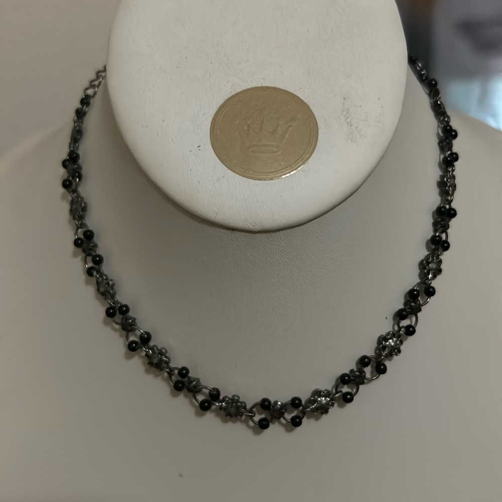 Black beaded with wire flowers, choker style.  ball chain closure.